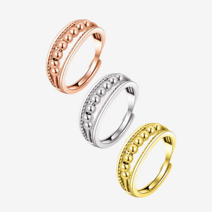 Silver, gold and rose gold worry rings on white background