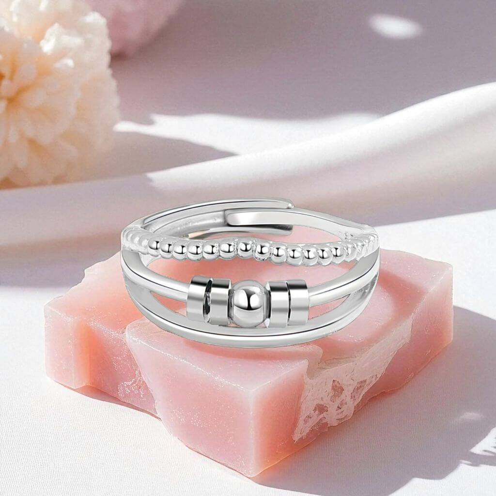 Silver ring on a pink soap block with a soft background