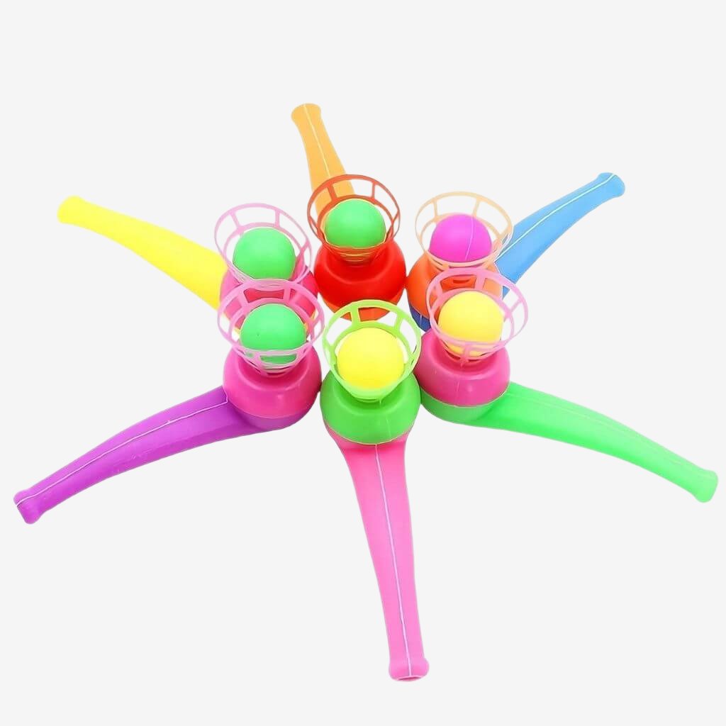 Six multi colored magic ball blow pipes in a circle on a white background