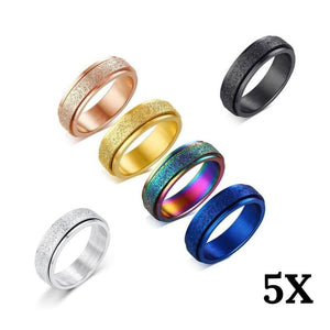 Six multi coloured fidget rings made of stainless steel on white background