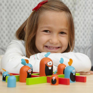 Smiling girl playing Gobblet Gobblers game by Blue Orange 