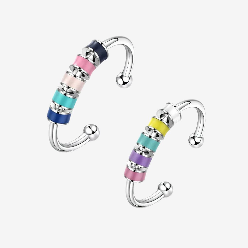 Stainless steel adjustable fidget rings with enamel beads blue and pink on white background