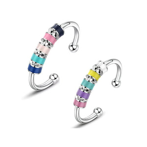 Stainless steel adjustable fidget rings with enamel beads blue and pink on white background