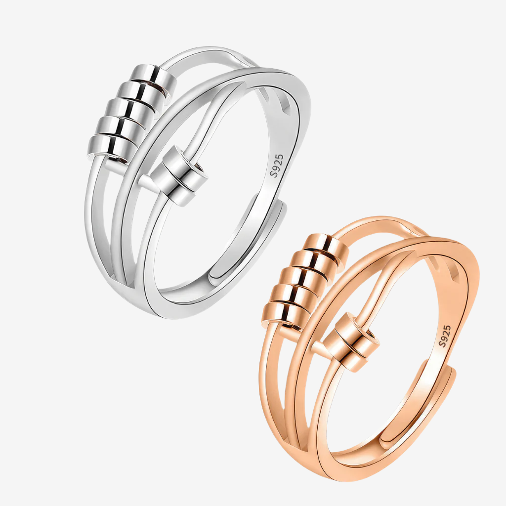 Sterling silver gold and silver worry rings with beads on white background