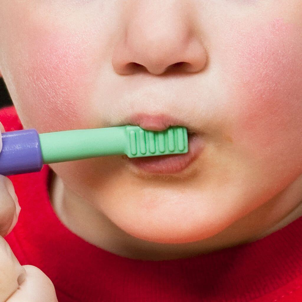 Therapist touching toddler's lips with a Ark Therapeutic Mini Tip for Z Vibe 