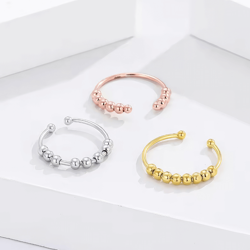 Silver adjustable rings with beads on white background