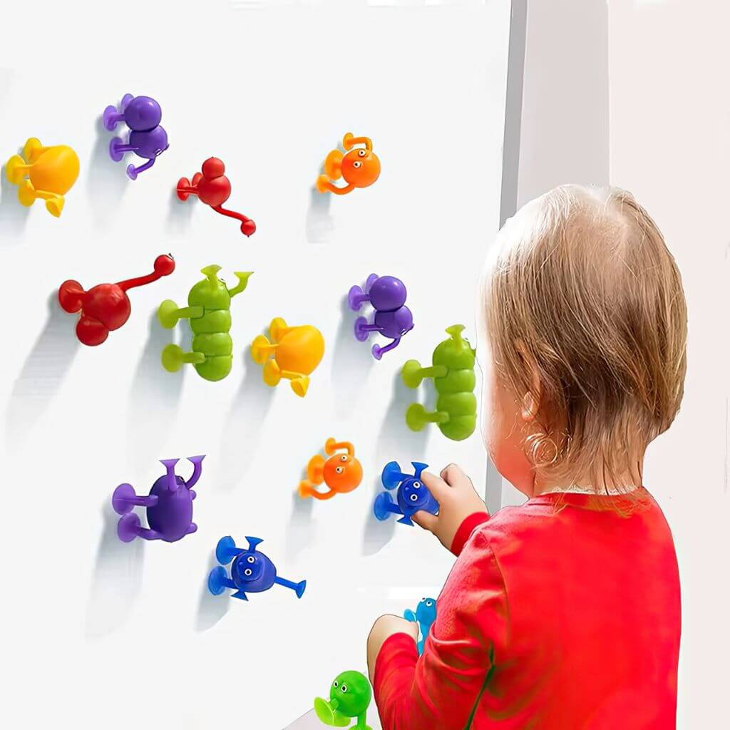 Toddler playing with suction cups toys