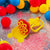 Trumpet multiple bubble blower and tray with balloons in background