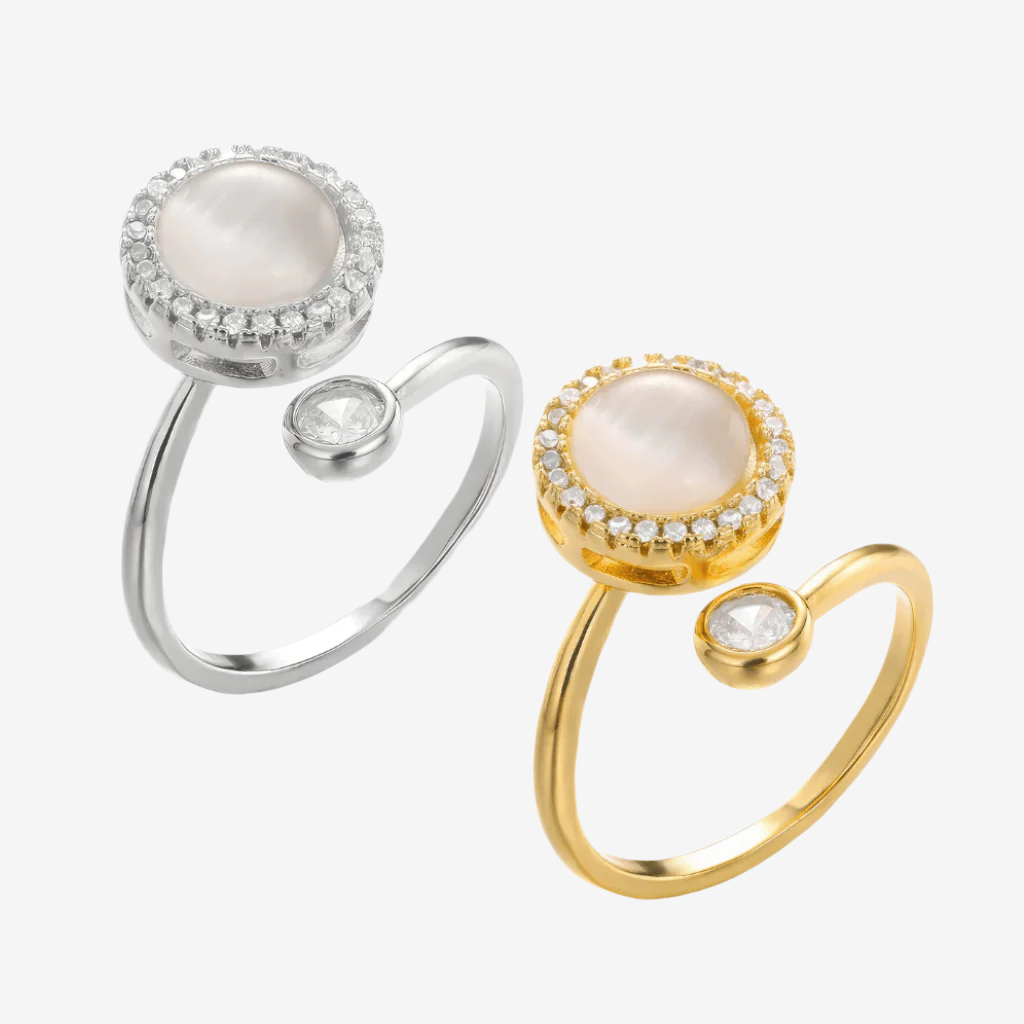 Two spinning rings with opal top on white background