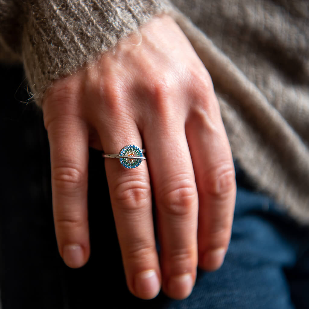 Woman wearing a planet adjustable anxiety in silver on grey sweater background