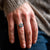 Woman wearing a planet adjustable anxiety in silver on grey sweater background