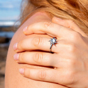 Woman's had on her shoulder wearing a sun ring with spinning top