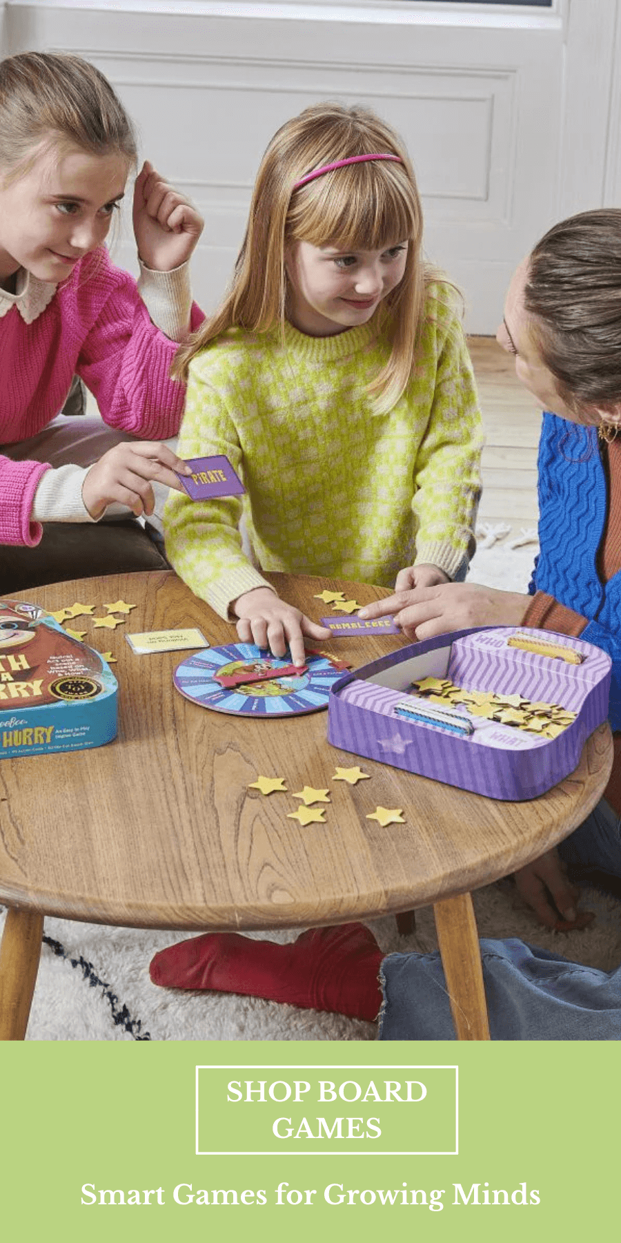 Woman and two girls playing a board game at a table