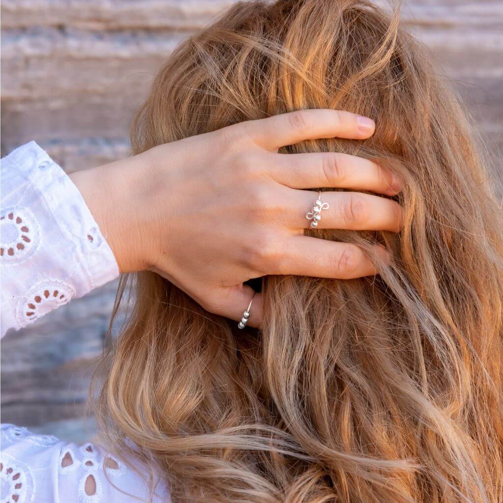 Woman wearing jewellery for anxiety holding her hair