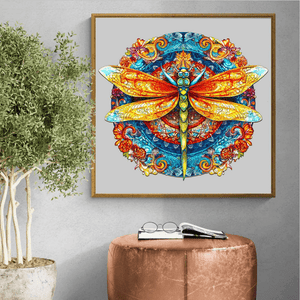 Wooden jigsaw puzzle for adults round dragonfly mandala on a wall next to a potted plant