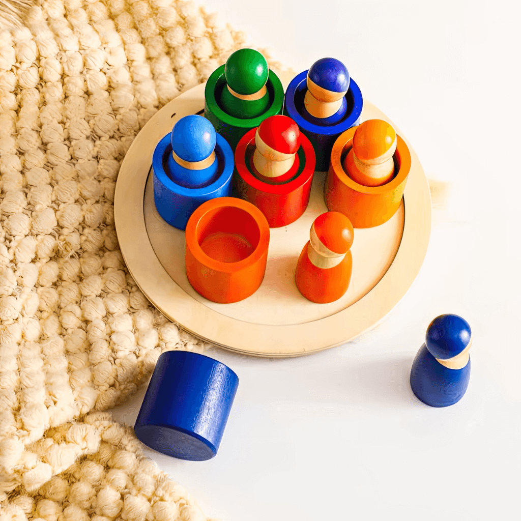 Wooden peg dolls on a tray