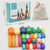 Wooden stacking stones box and contents on grey background