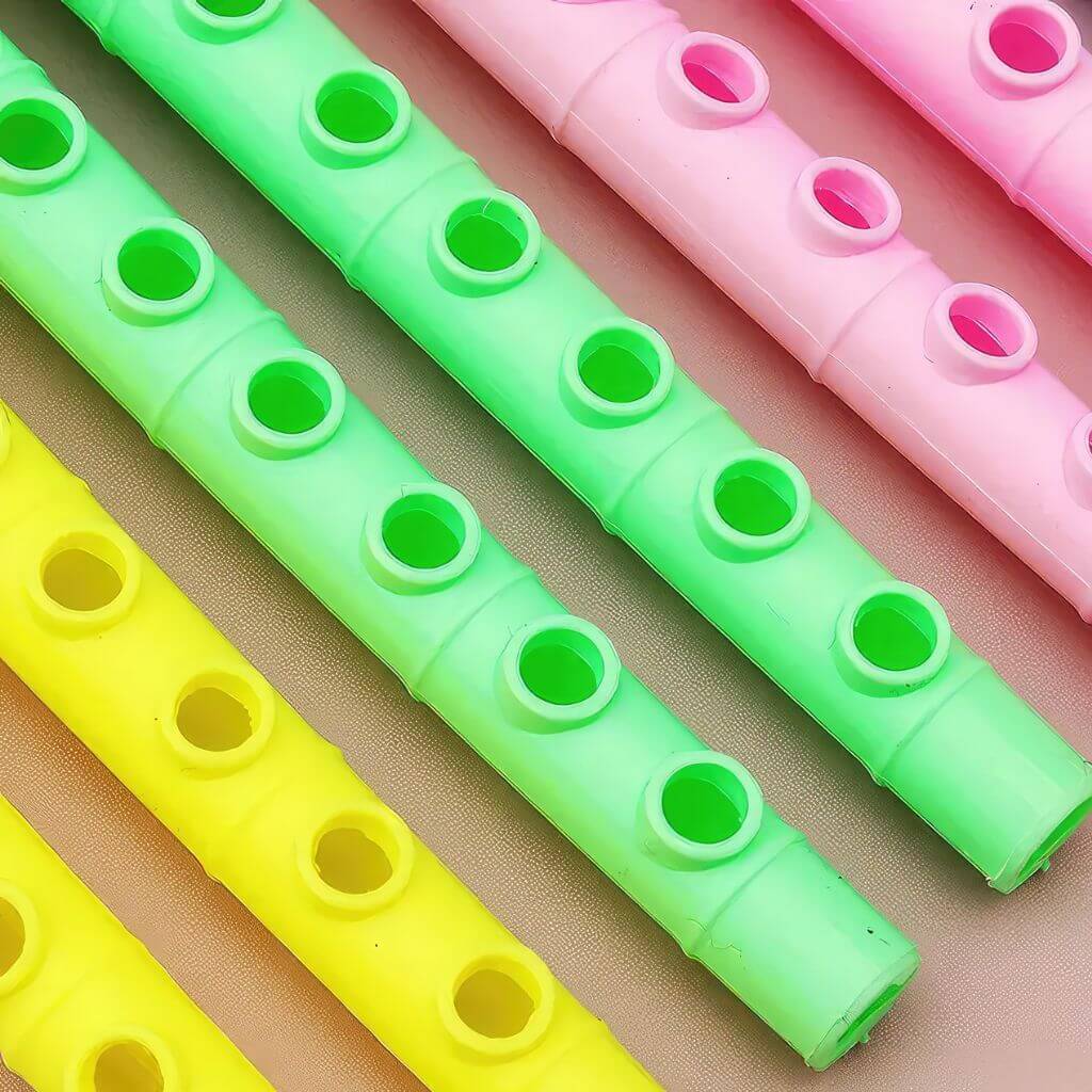 Flute whistles with dimensions on a wooden surface