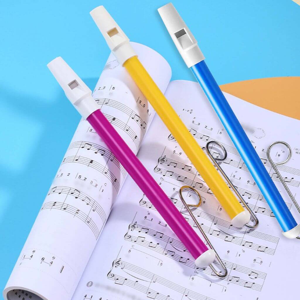 Yellow, purple and blue slide whistles on a white background