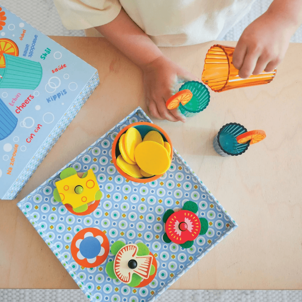 Top view of Djeco Mia and Leo appetizer wooden play food set with snacks and serving accessories