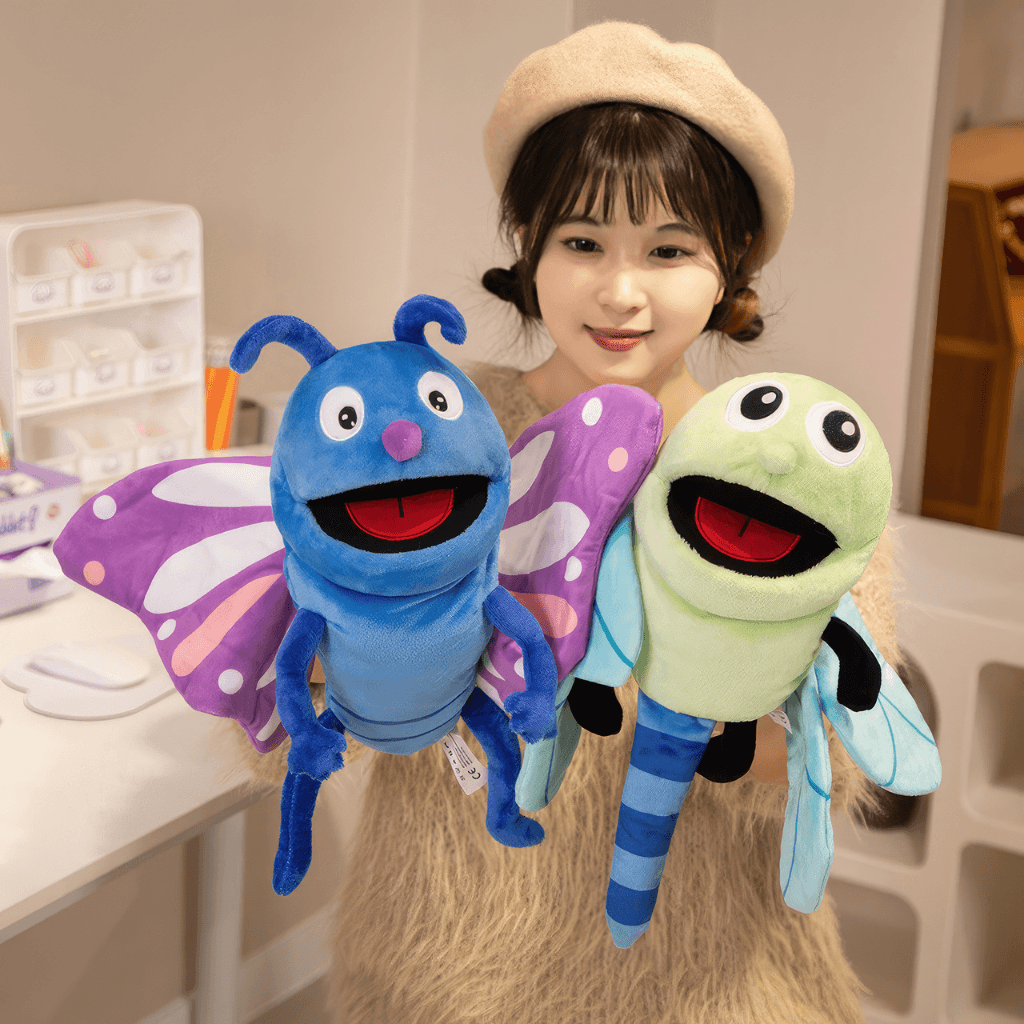 Child holding dragonfly and butterfly hand puppets during imaginative play activity