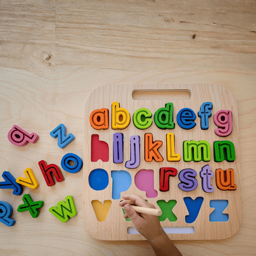 Child placing letters into Kiddie Connect ABC trace puzzle while developing fine motor and letter recognition skills