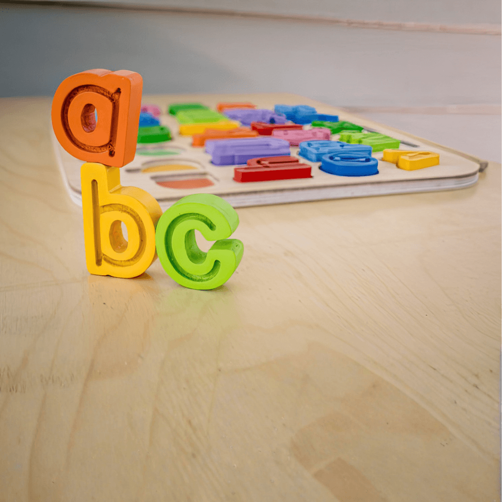 Close up of colourful lowercase wooden letters from Kiddie Connect ABC trace puzzle showing tracing grooves