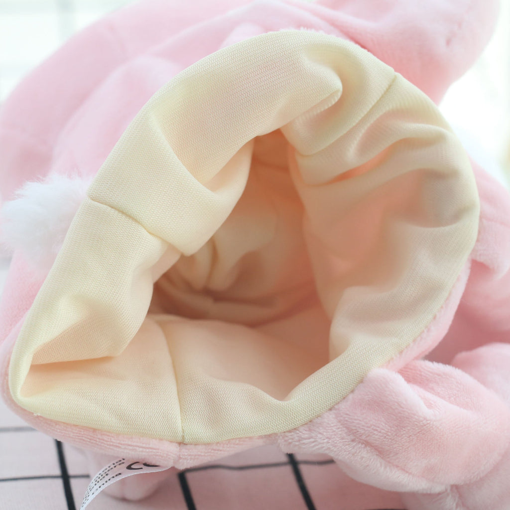 Close-up of the cream fabric interior lining of the pink rabbit hand puppet showing the hand opening
