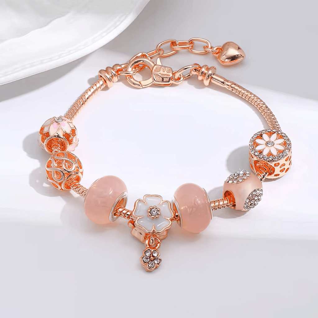 rose gold charm bracelet detail — floral enamel CZ centre pink resin beads filigree sphere — Sensory Stand