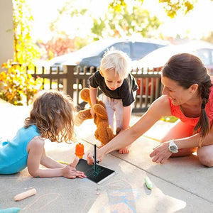Mom watching children play with a 8.5 inch LCD writing board best drawing tablet for beginners