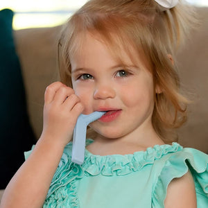 Caucasian girl chewing on Ark's Y chew textured sensory chew in light blue YC100BlueAW