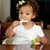 Toddler girl eating yogurt with Ark's Y shaped textured sensory chewing tool