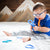 Autistic toddler chewing on Ark's guitar oral motor sensory chew toy