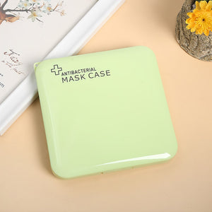 Green face mask case holder on yellow background