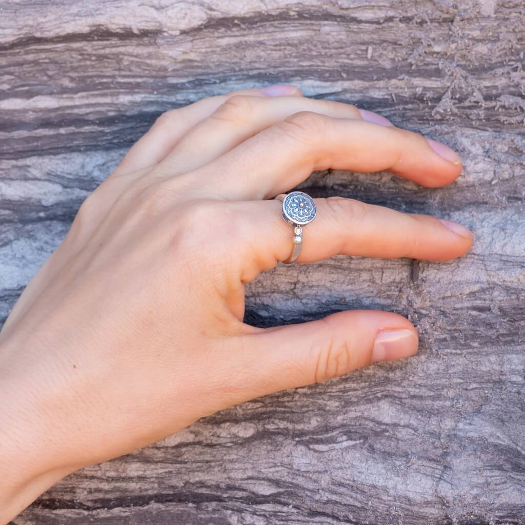 Fidget ring Australia made of sterling on a woman's hand stone background