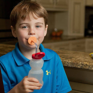 Boy drinking from a honey bear cup by Ark Therapeutic