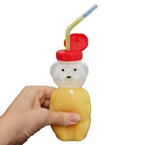 Hand squeezing a honey bear straw cup by Ark Therapeutic