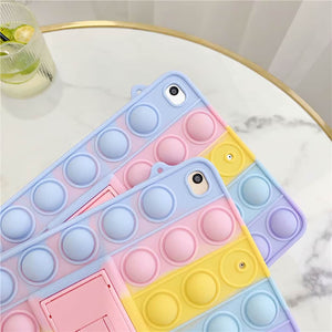 2 cute iPad cases fidget popper in pastel colpurs on a marble table