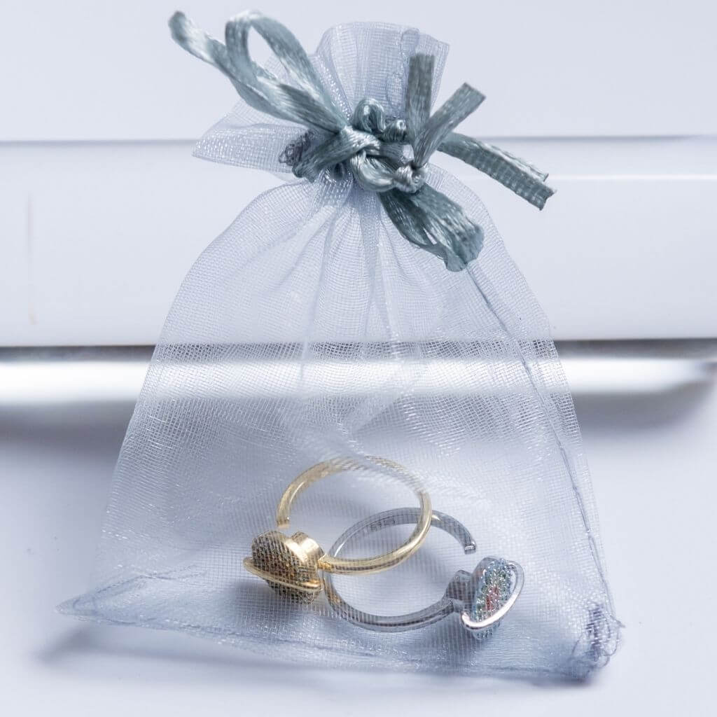 Silver and gold planet spinner rings in Australia in an organza bag