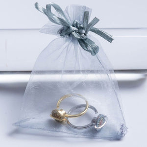 Silver and gold planet spinner rings in Australia in an organza bag