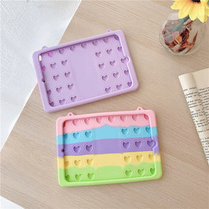 Pop its silicone pastel iPad cases with hearts on a table