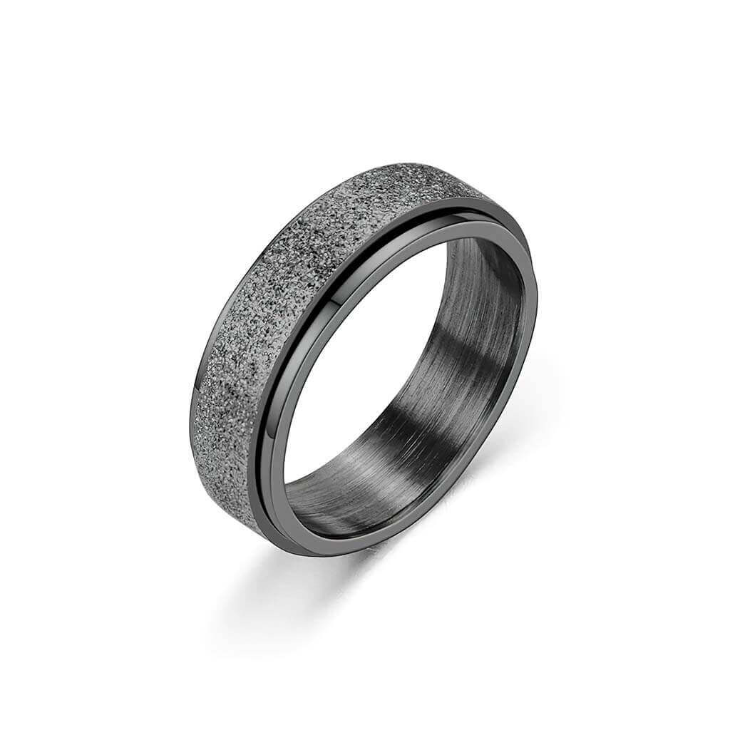 Black stainless steel sparkly spinner ring on white background