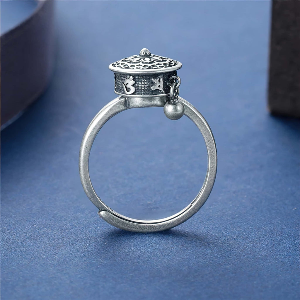 Sterling silver Buddhist Tibetan prayer wheel anxiety ring on blue background