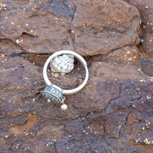 Sterling silver Buddhist Tibetan prayer wheel fidget ring Australia on brown stone background