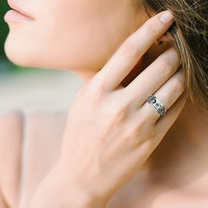 Woman touching her ear wearing a sun moon and star silver fidget ring
