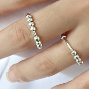Woman wearing 2 sterling silver bead spinny rings