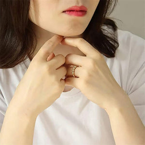 Woman wearing a stainless steel gold ring for anxiety