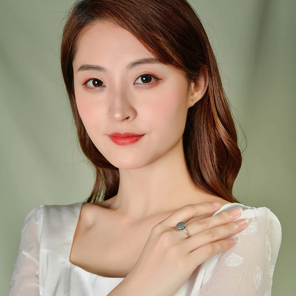 Woman wearing Buddhist prayer wheel spinner rings australia